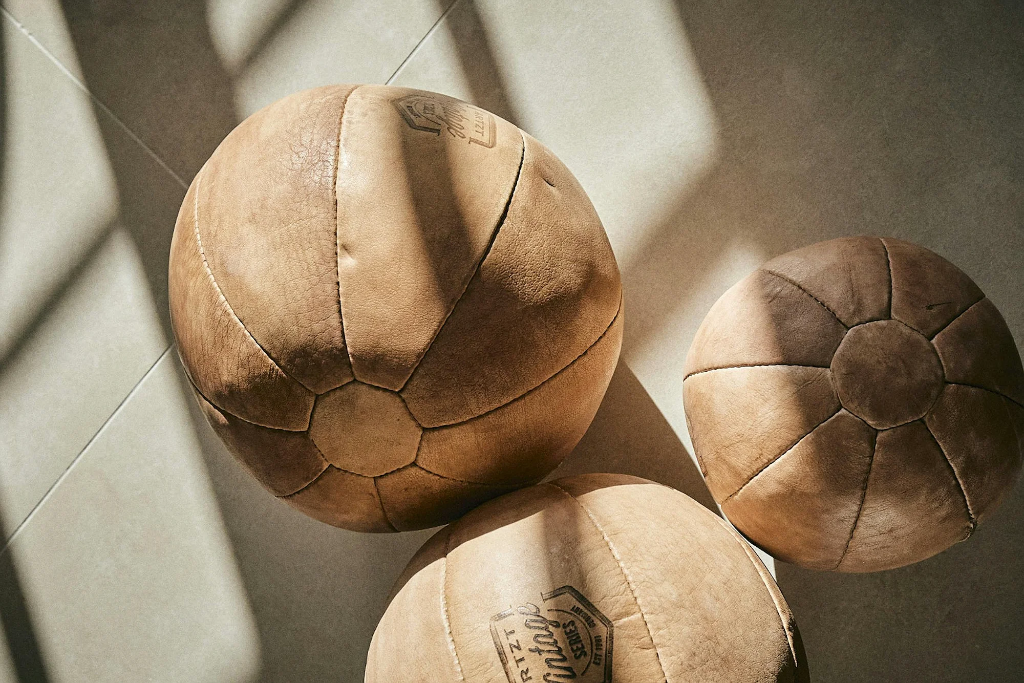 Vintage leather medicine balls in natural light at ByMilagro luxury villa Mallorca