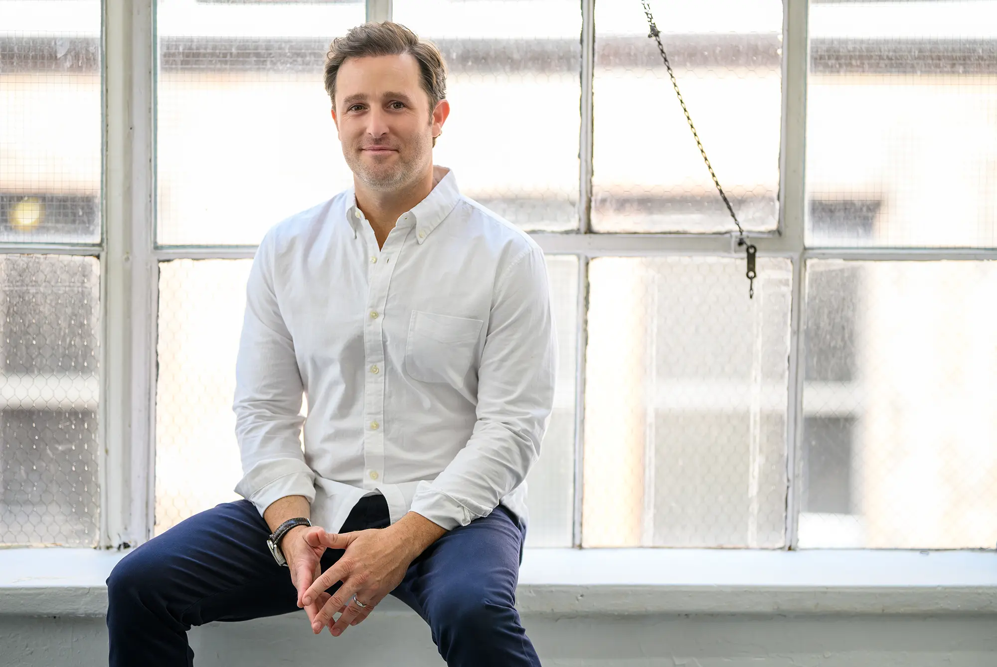Rise Dental founder sitting on a window