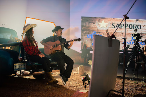 A man and a woman playing guitars.