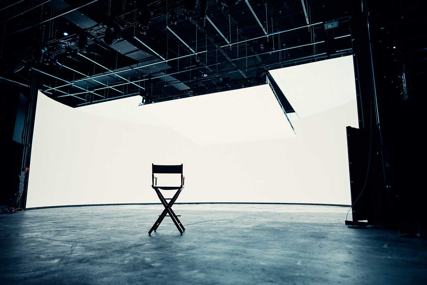 Studio LED setup featuring a director chair placed in the center of the stage.