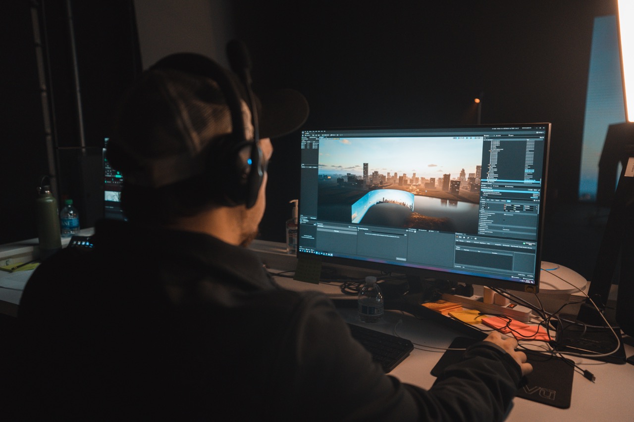 A man sitting in front of a computer display participating on a workshop.