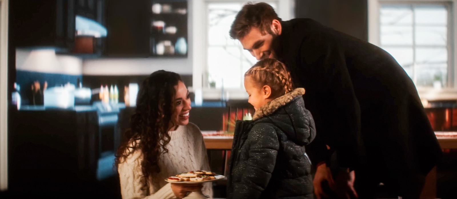 A picture of a man, a women and a little girl.