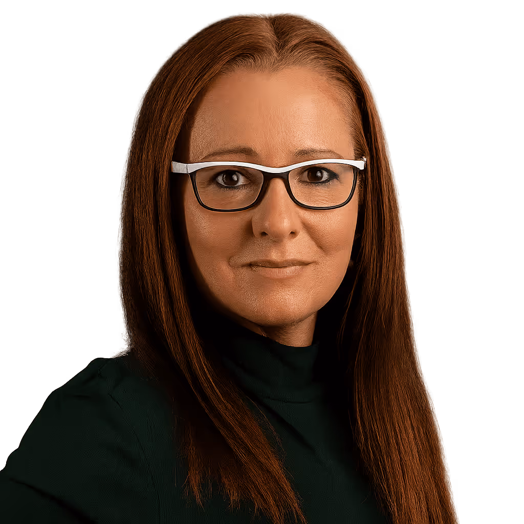Woman with straight brown hair wearing black and white glasses and a dark top against a black background.