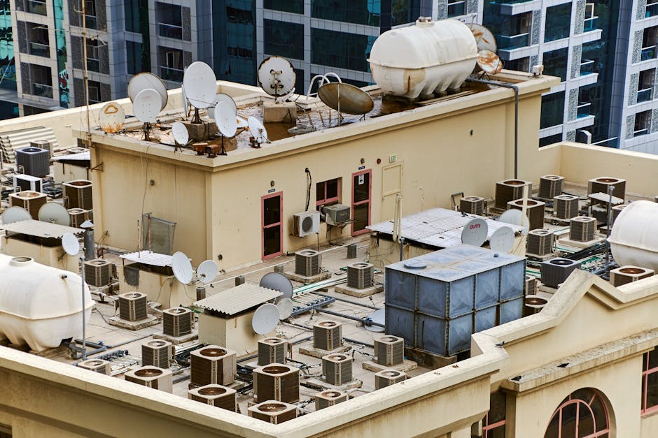 Commercial rooftop HVAC units with city skyline background - commercial air conditioning orlando