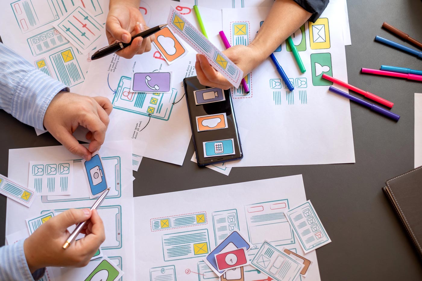 Graphic designers working with layouts on the Central Coast
