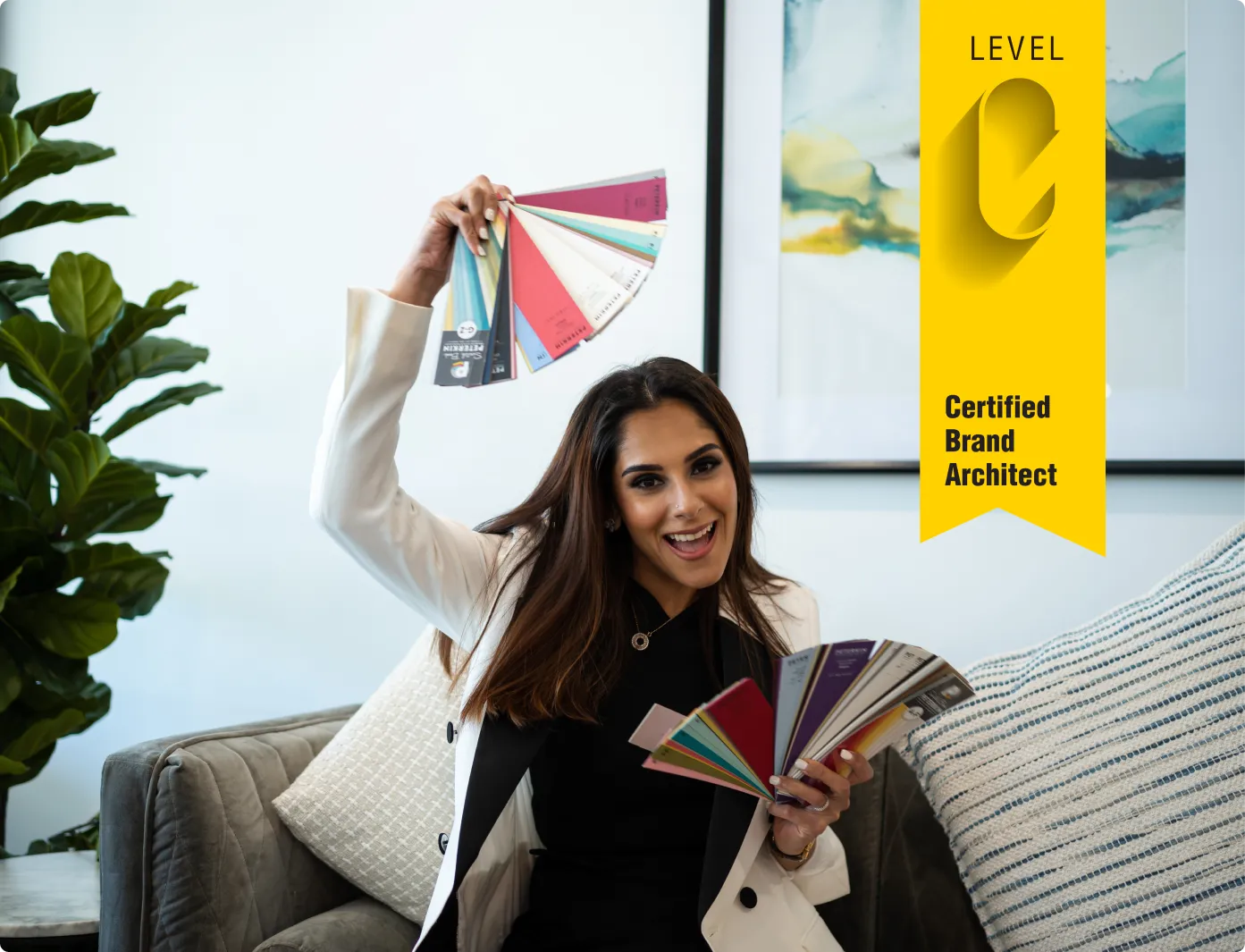 Praveen holding up a set of colour swatches above her heead