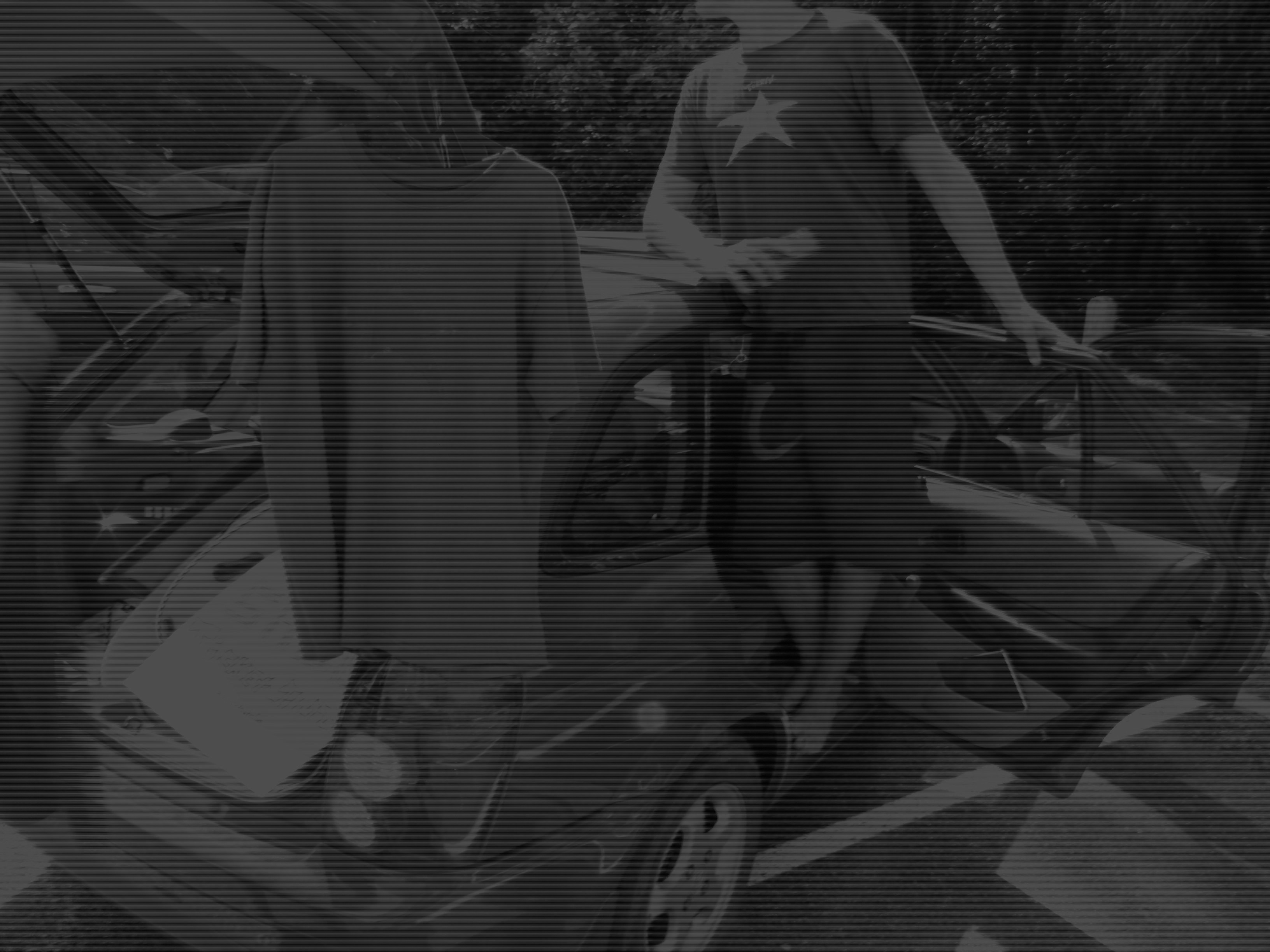 A man standing next to a car with the door open.