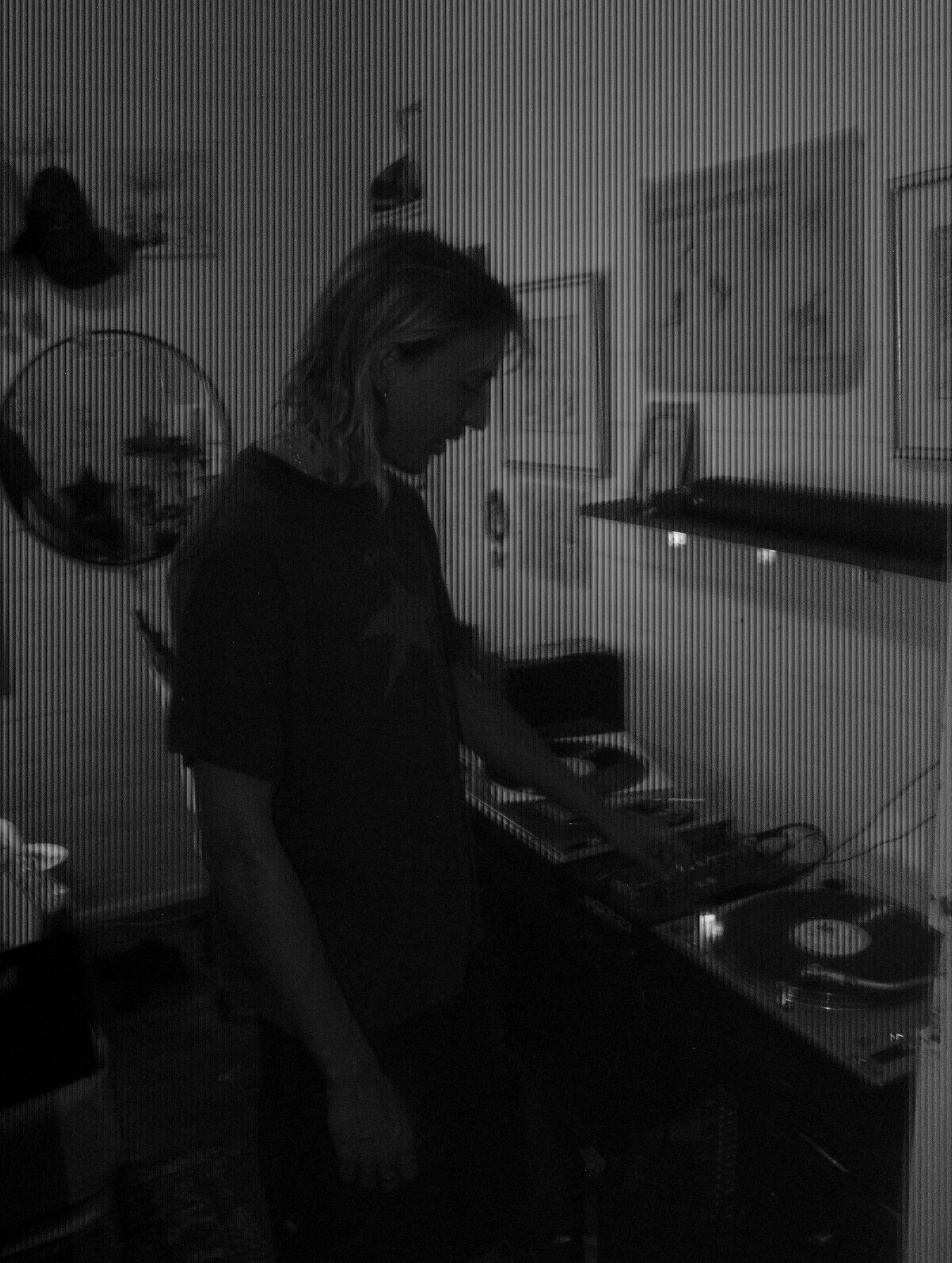 A man standing in front of a record player.