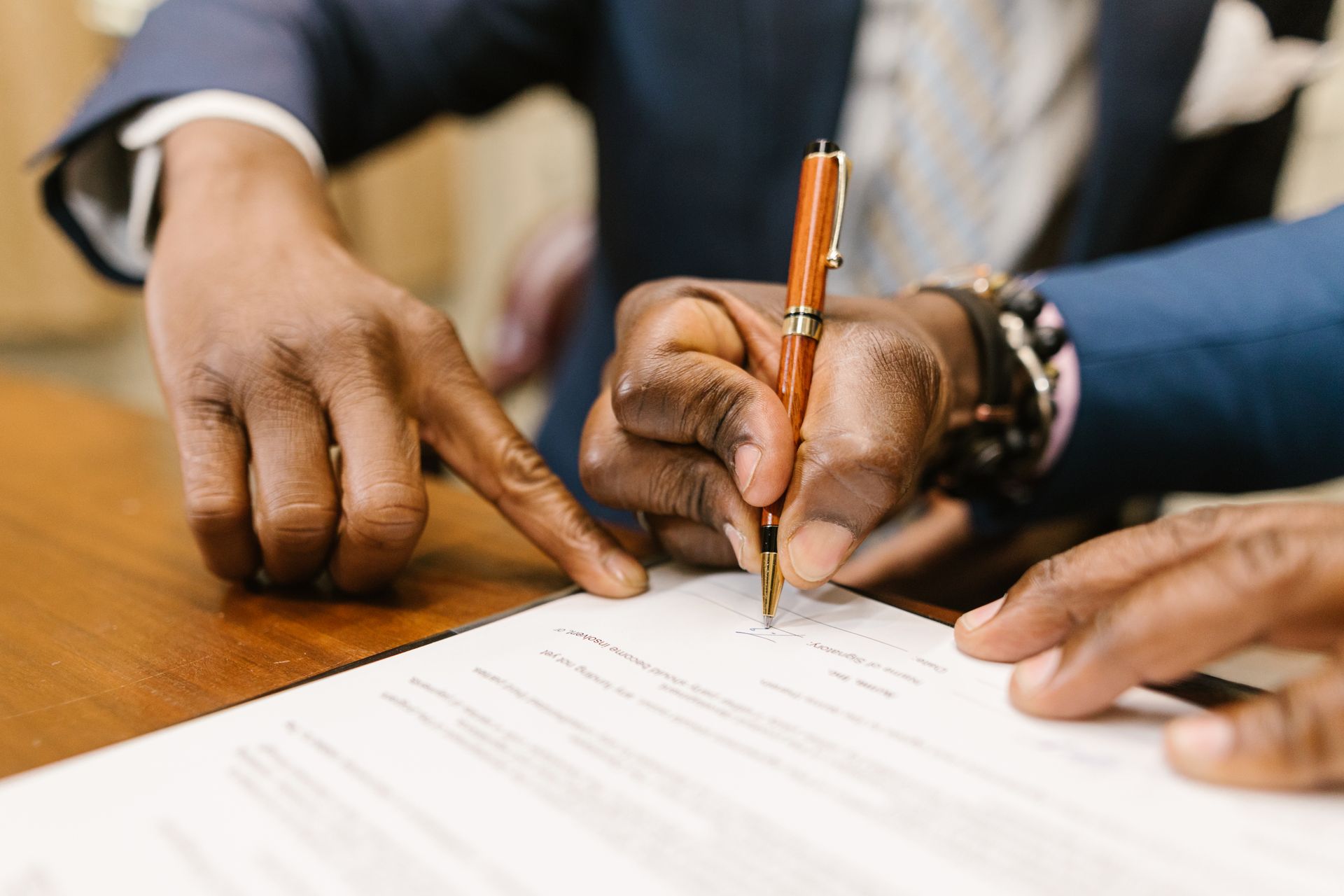 Business professionals signing a contract
