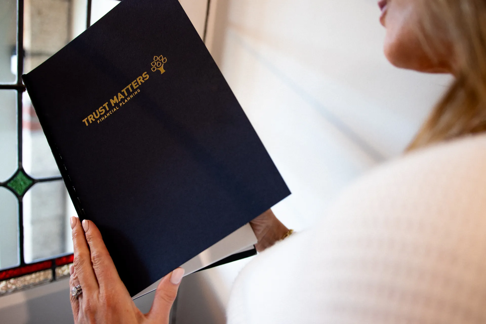 Woman holds a booklet.