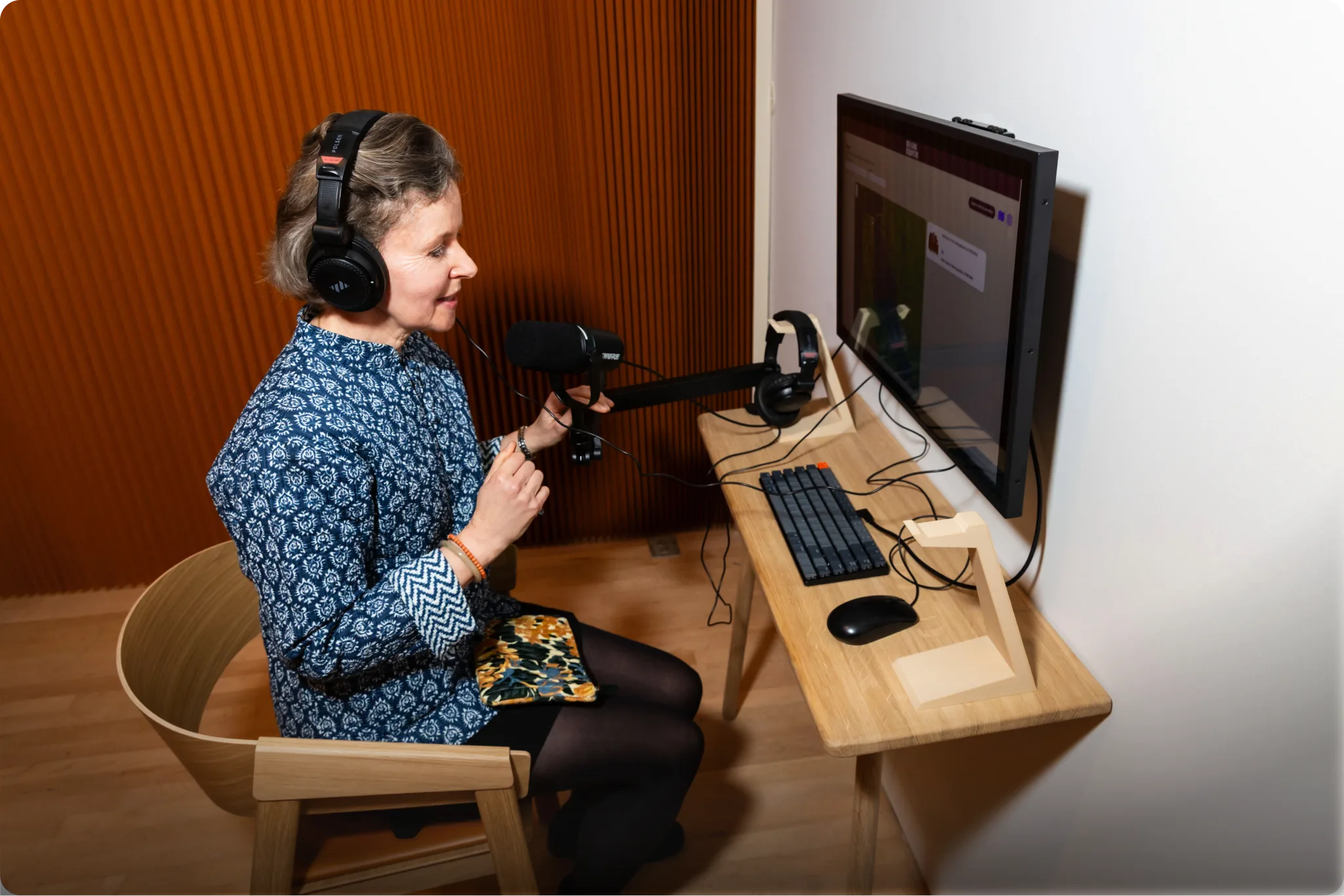 Woman with headphones speaking into a microphone at SFMOMA using a Guru Experience Museum interactive.