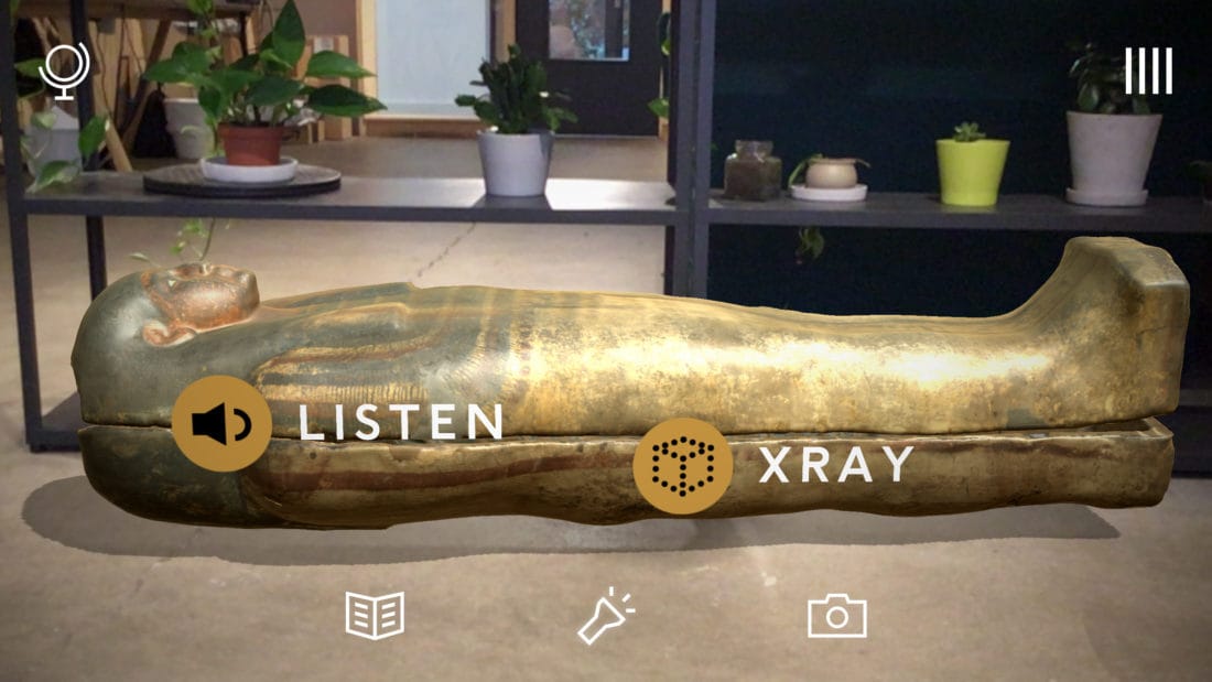 A gilded Egyptian sarcophagus placed in a living room through the BBC Civilizations AR app, with Listen and Xray buttons overlaid.