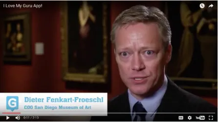 Video still of San Diego Museum of Art COO Dieter Fenkart-Froeschl speaking in a gallery, from the testimonial video I Love My Guru App.