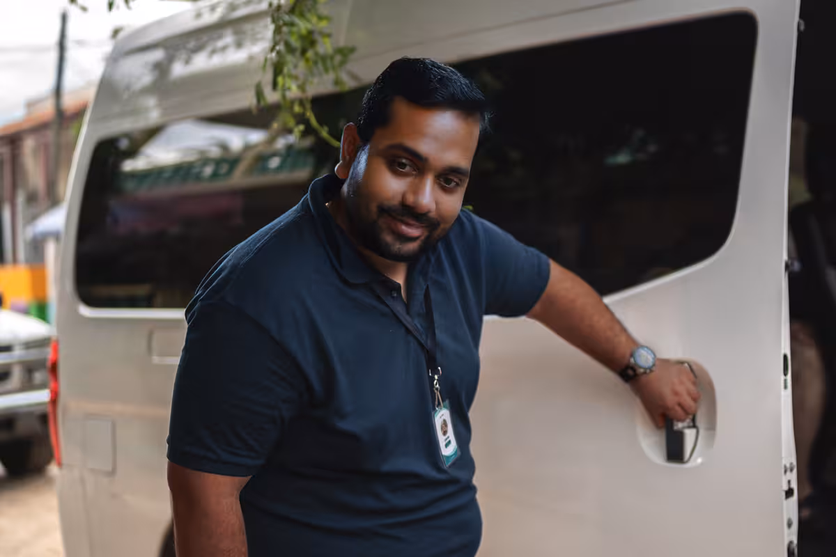 Indian driver in front of van