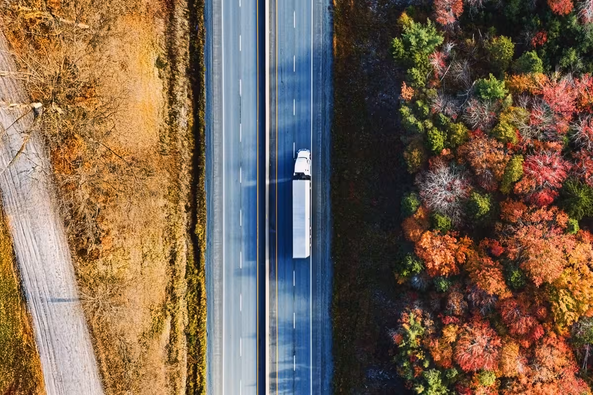 Overhead view of a truck driving down a country road