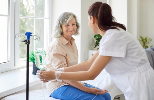 Healthcare provider fixing IV of a patient