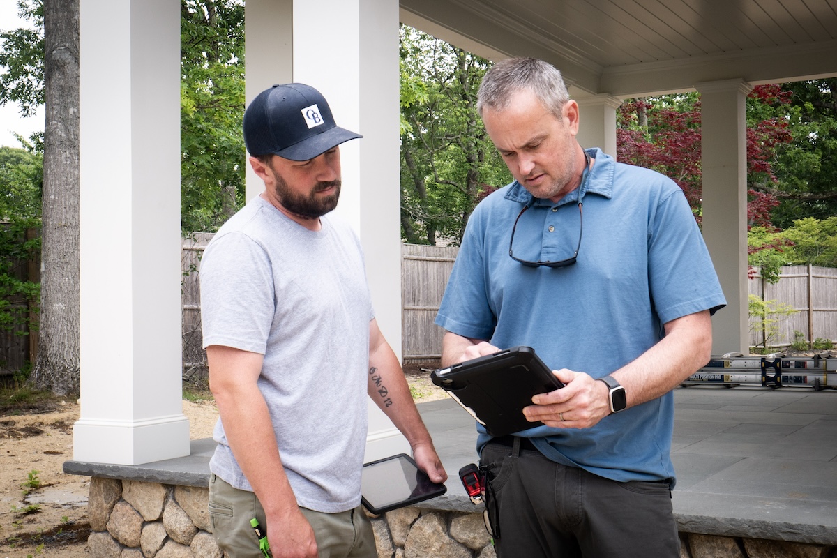 O'Neill Bowes staffers, Alec Peters and Jeff Glines, confer on a job site in Barnstable MA.