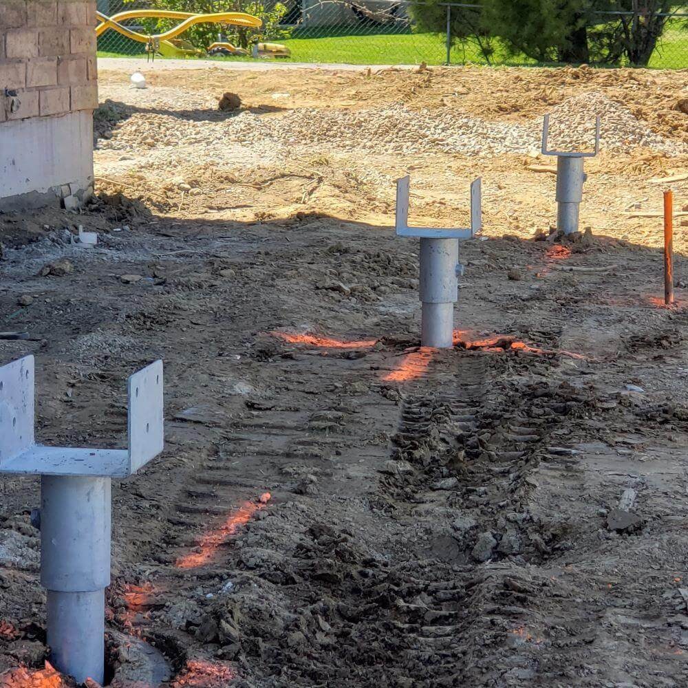 White pipes in dirt field