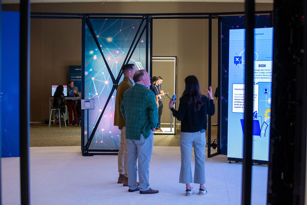 Attendees explore an Imprint-designed interactive experience booth at the GHX Summit