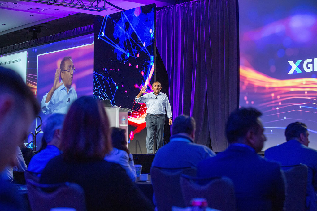 A speaker presents on Imprint's custom stage design at the GHX Summit