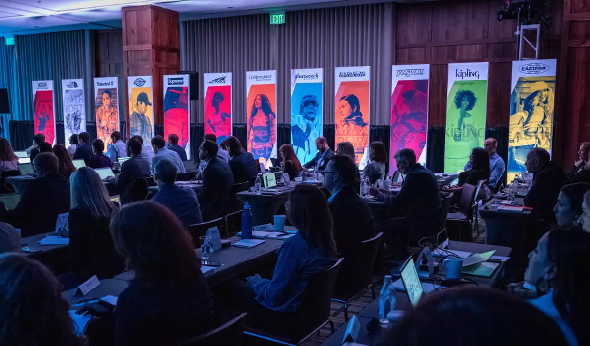 Attendees sit beneath Imprint's brand gallery banners at VF Corporation's Investor Day