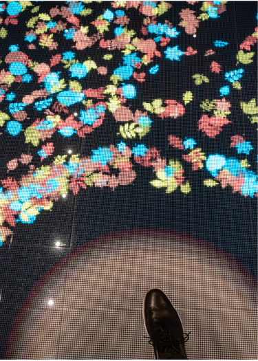 A guest interacts with Imprint's LED floor installation at VF Corporation's Investor Day