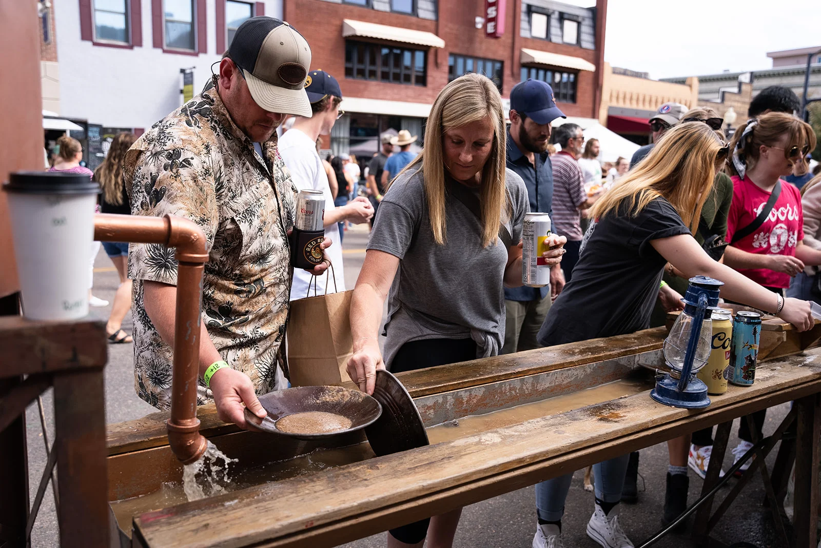 Guests try Imprint's gold-panning activation at the Coors Brewery 150th Celebration
