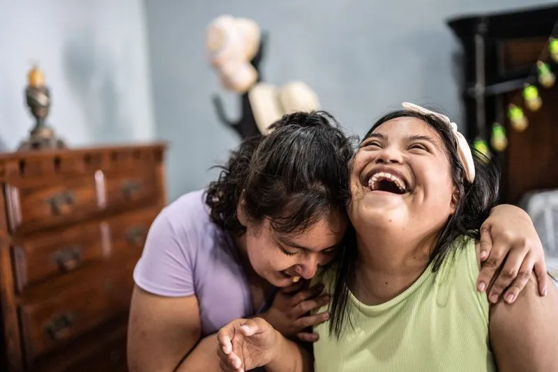 Two friends laughing loudly