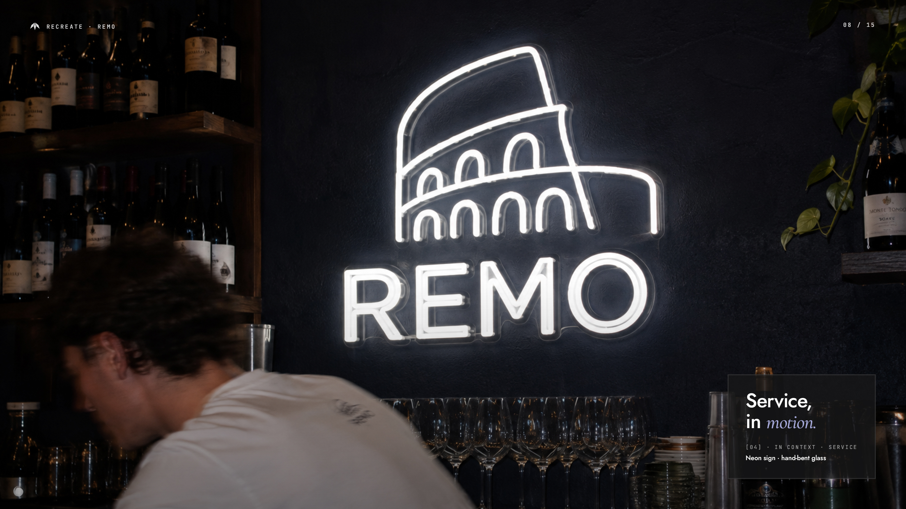 Illuminated REMO logo and restaurant signage inside the pizzeria