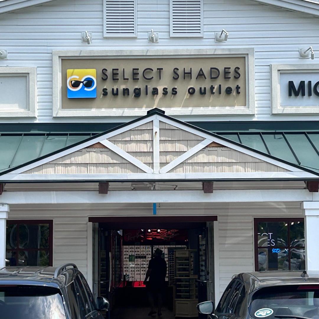The inviting storefront of Select Shades Sunglass Outlet at Outlets of Lake George, NY.
