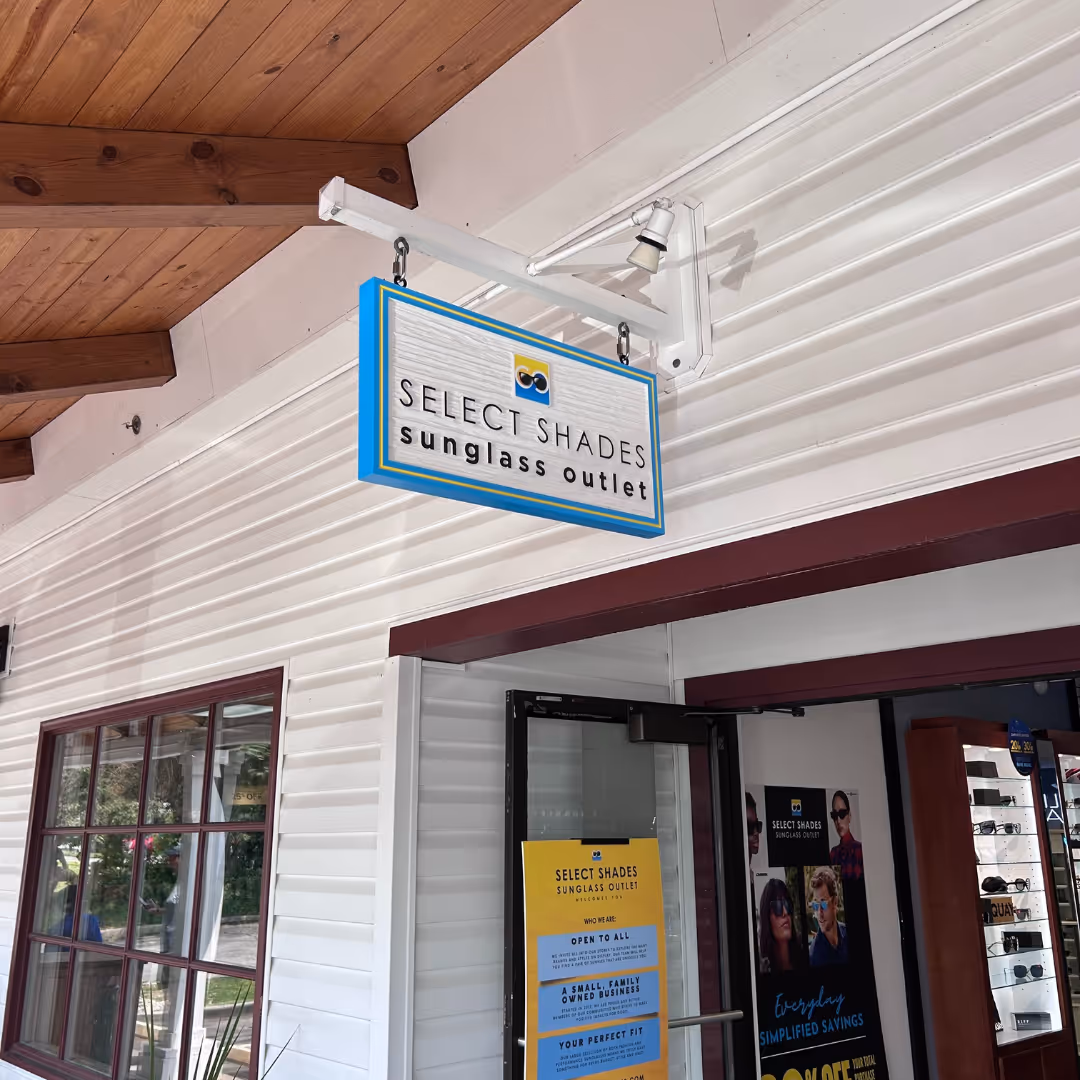 Select Shades Sunglass Outlet storefront at Lake George, NY – family-owned designer sunglasses store offering Ray-Ban, Oakley, and more at outlet prices near Adirondack shopping district.