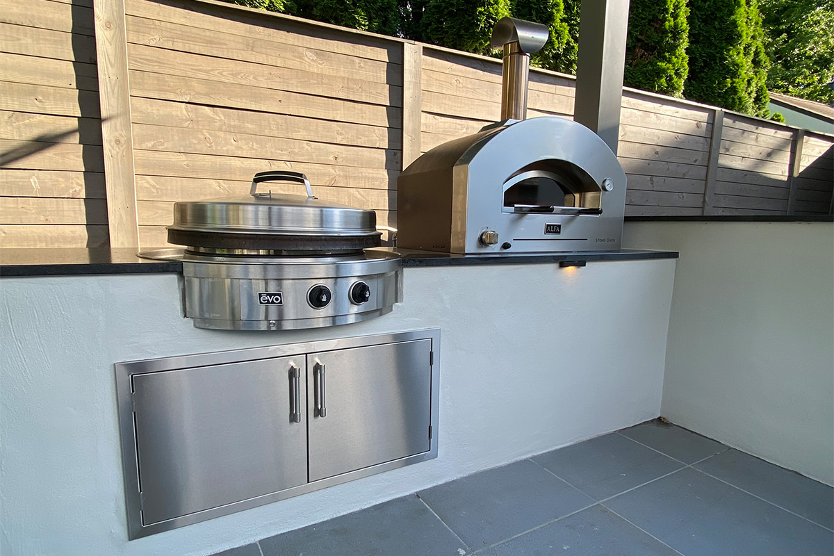 A custom pergola sits next to the swimming pool, complete with an outdoor kitchen, bar, TV, and fire features.