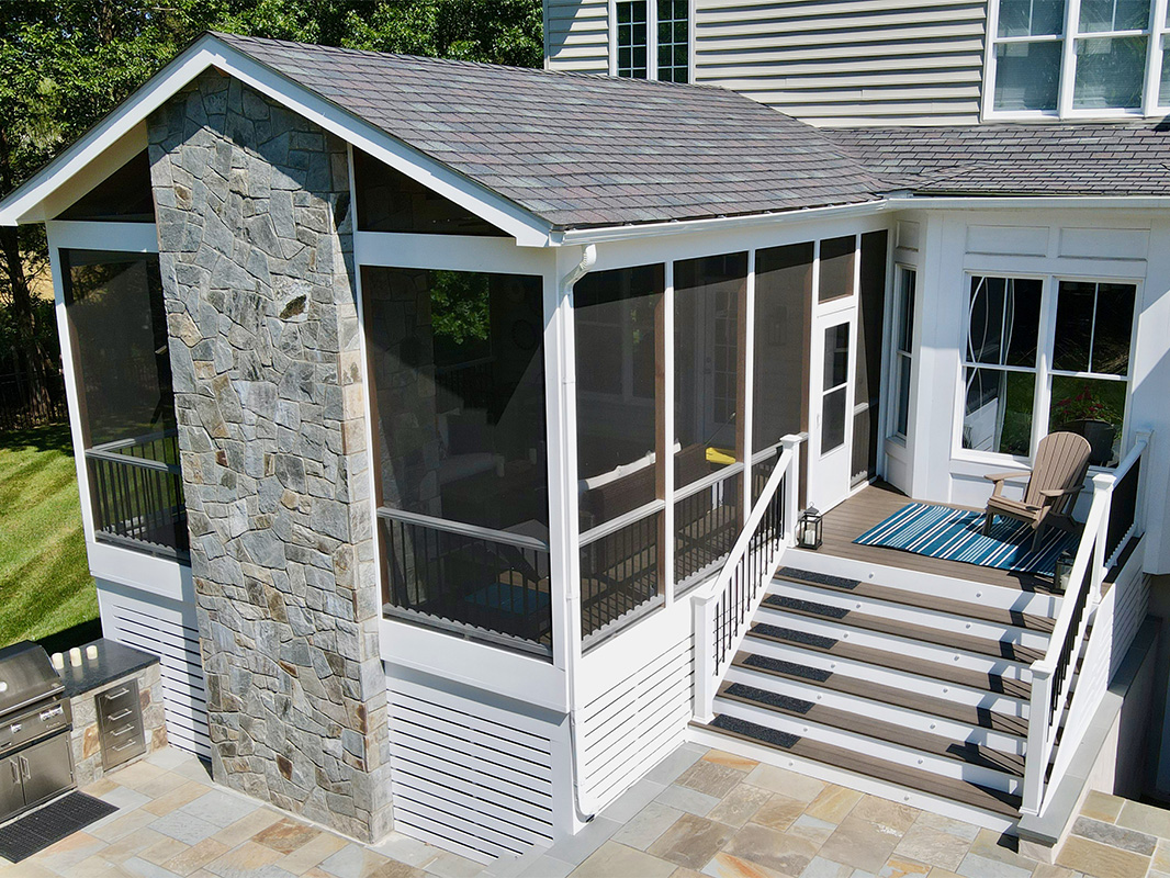 Gorgeous backyard retreat with a covered, screened in porch. This project was designed and built by Rossen Landscape.