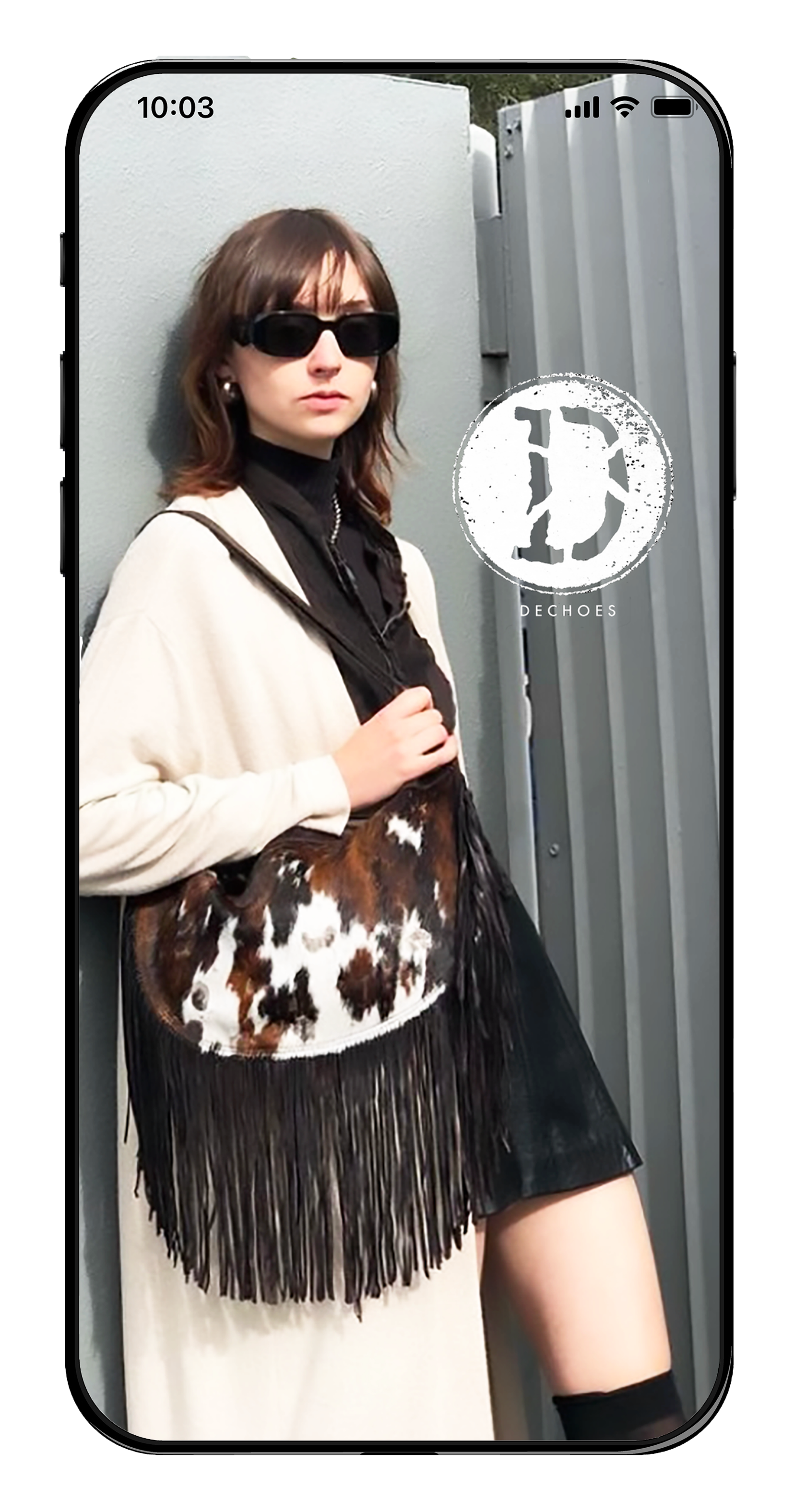 A mobile phone screen showing a woman holding a bag and the store's logo