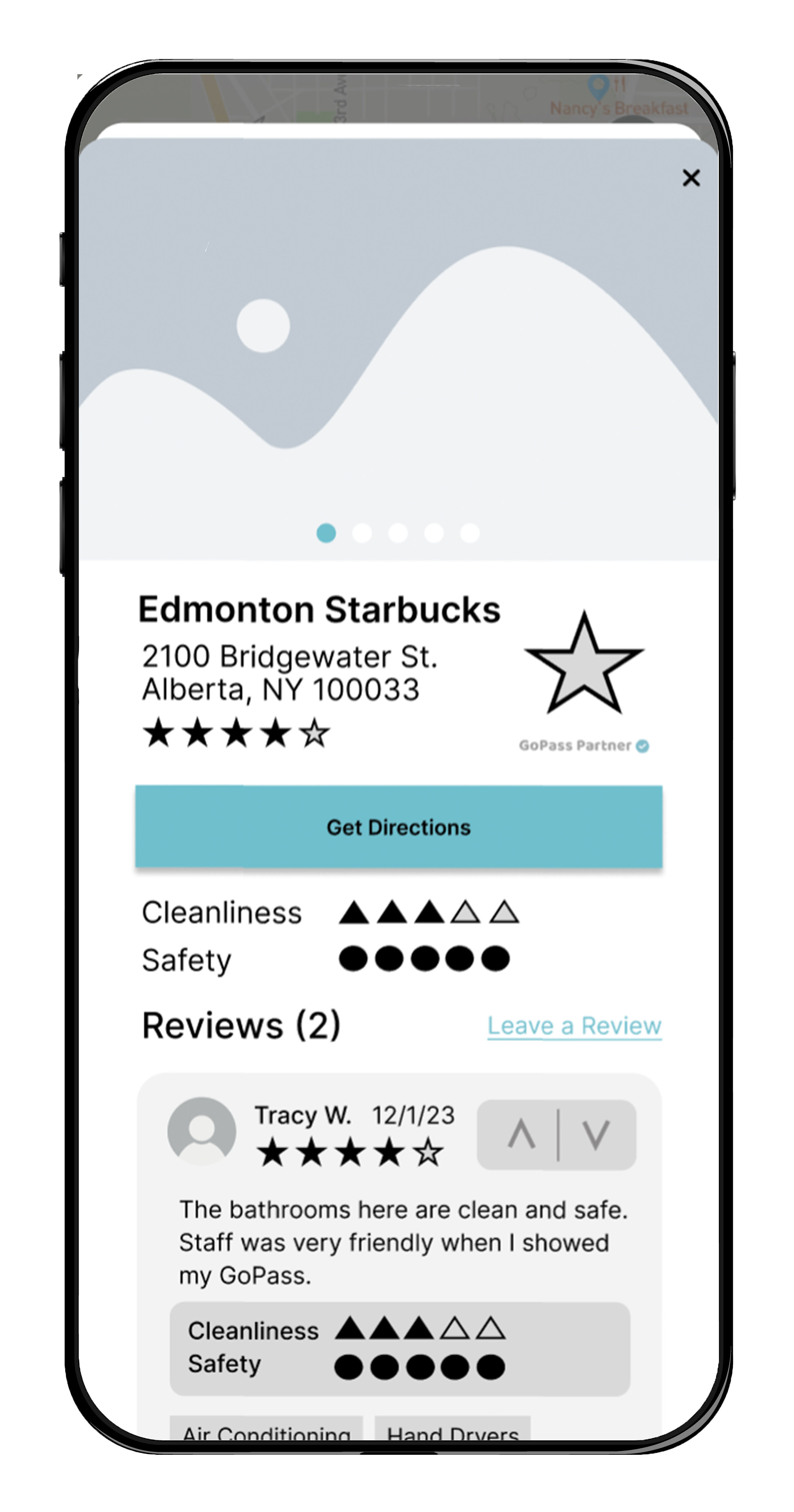 A mobile phone screen showing a placeholder photo and information about a bathroom with a favoriting star