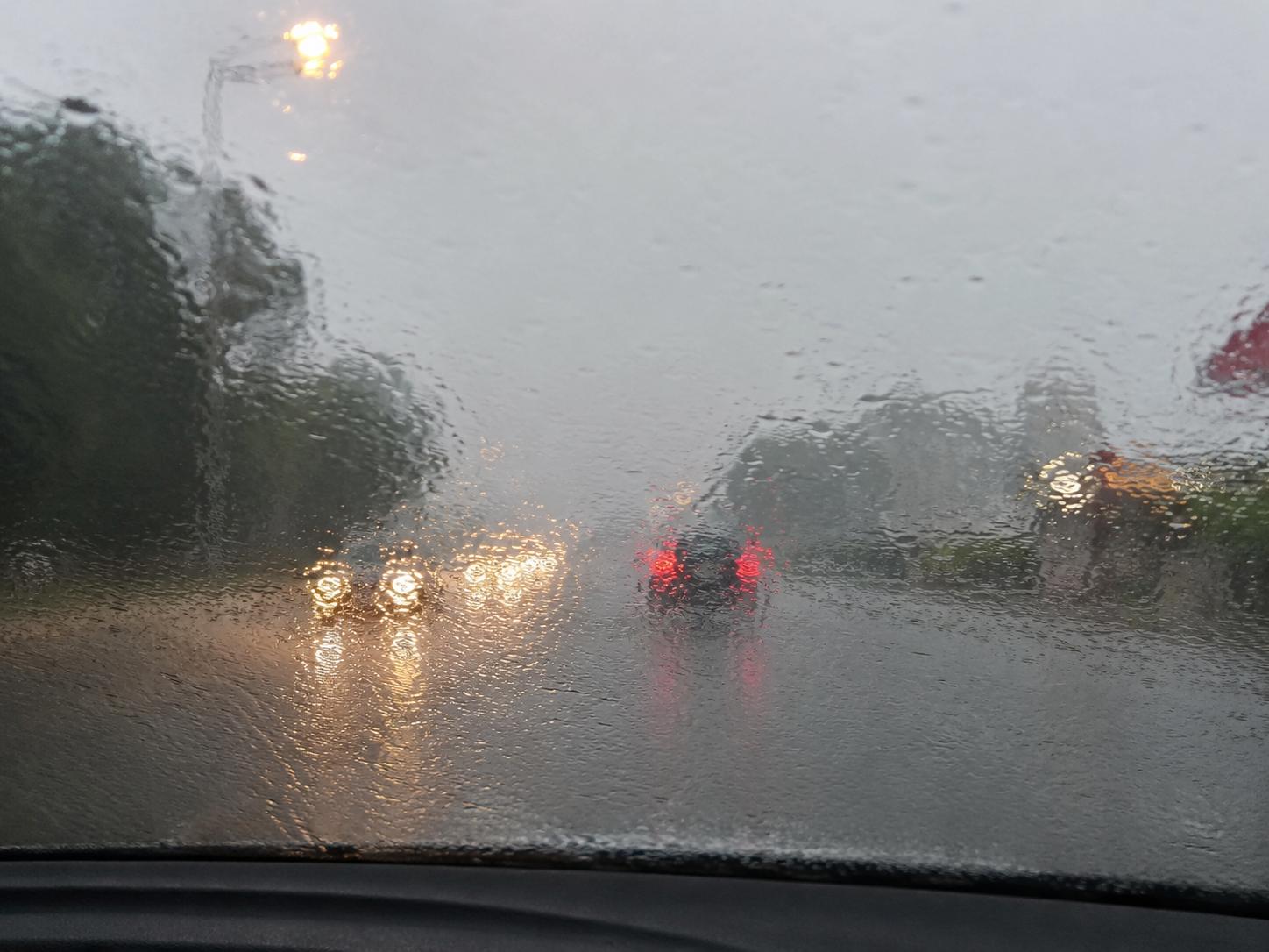 View through windscreen without Si-Plus — water clinging to glass, reduced visibility in Singapore rain