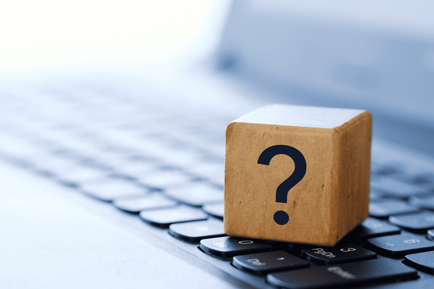 Question mark cube on laptop keyboard