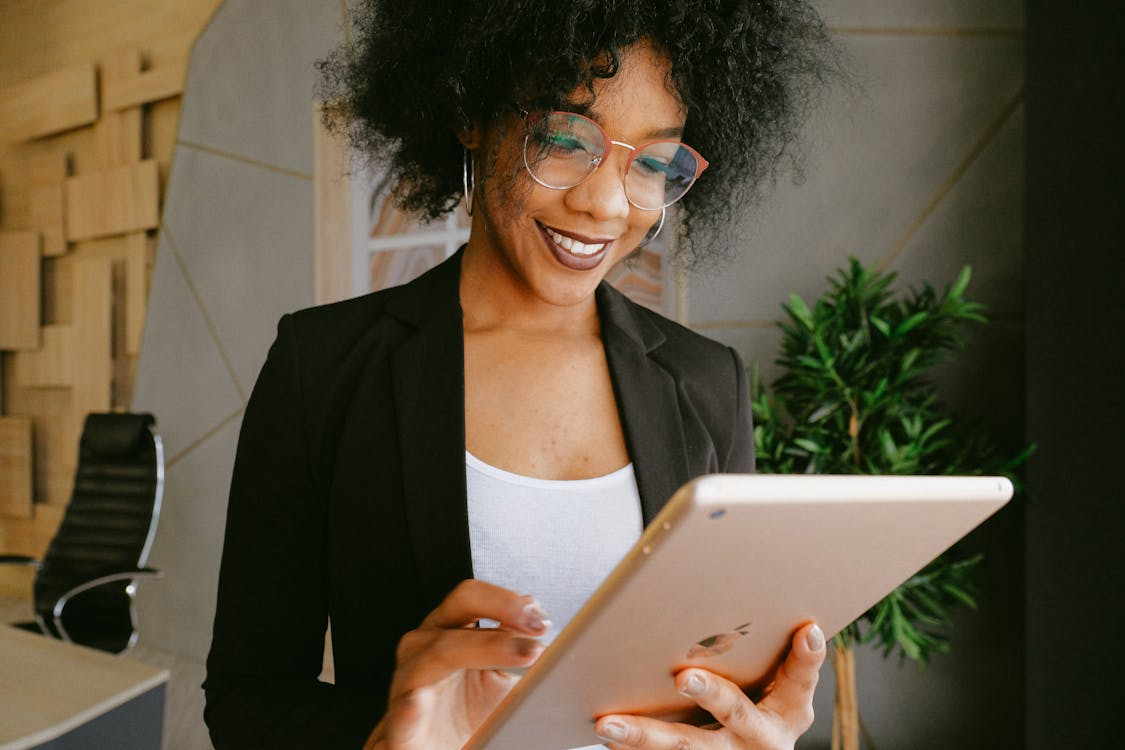 person using a tablet to check off tasks
