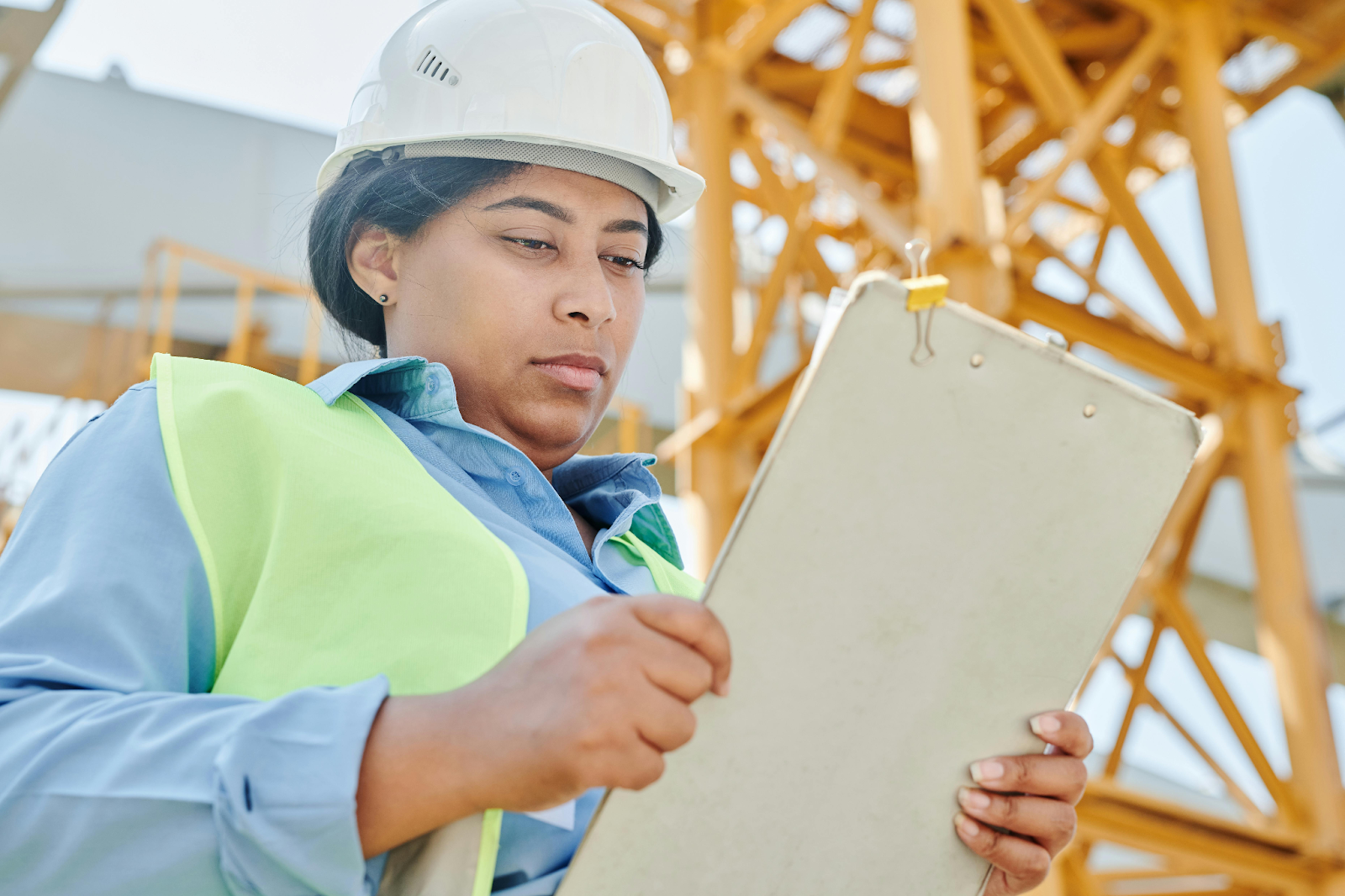Woman Wearing Safety Helmet and Checklist