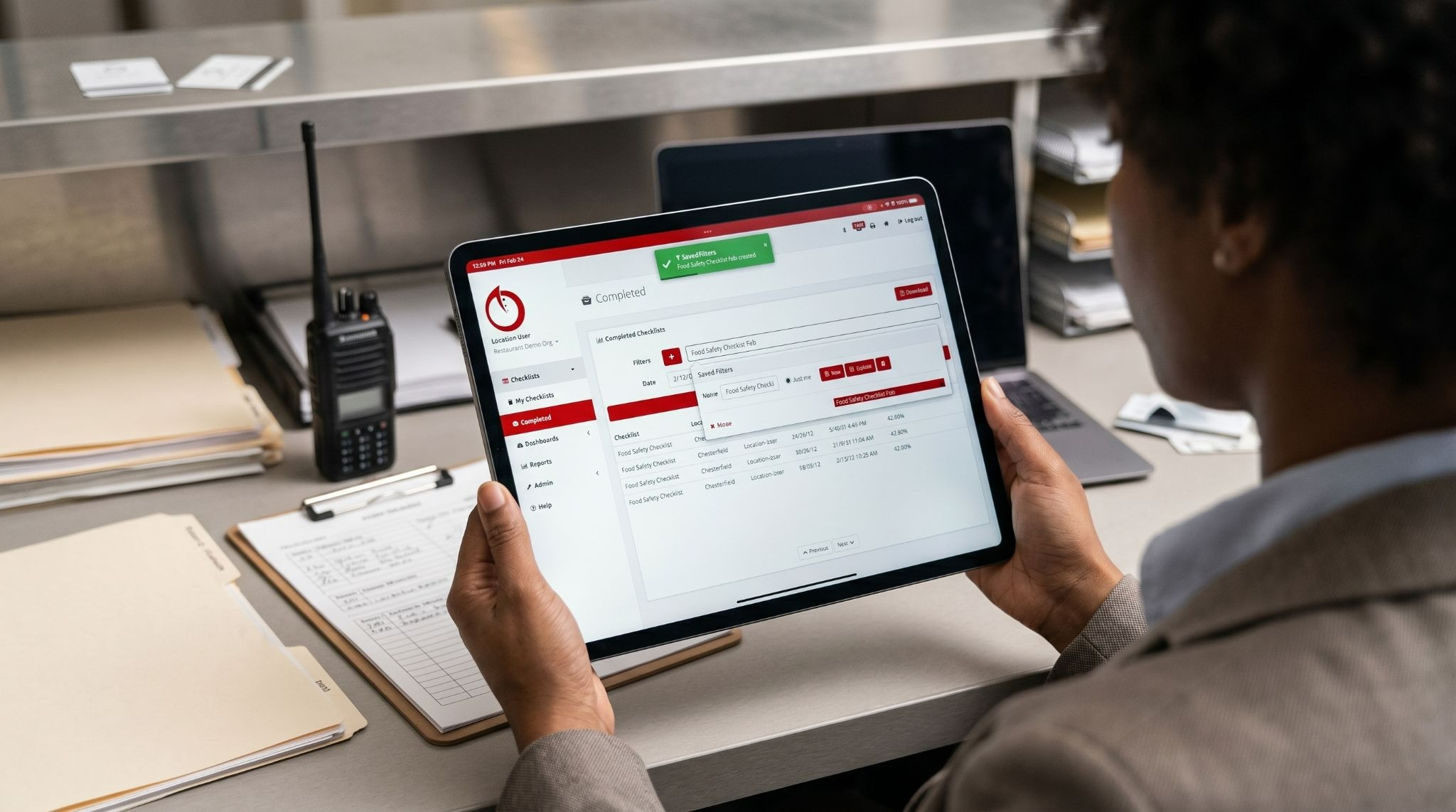 Operations manager reviewing compliance checklists on a mobile device 