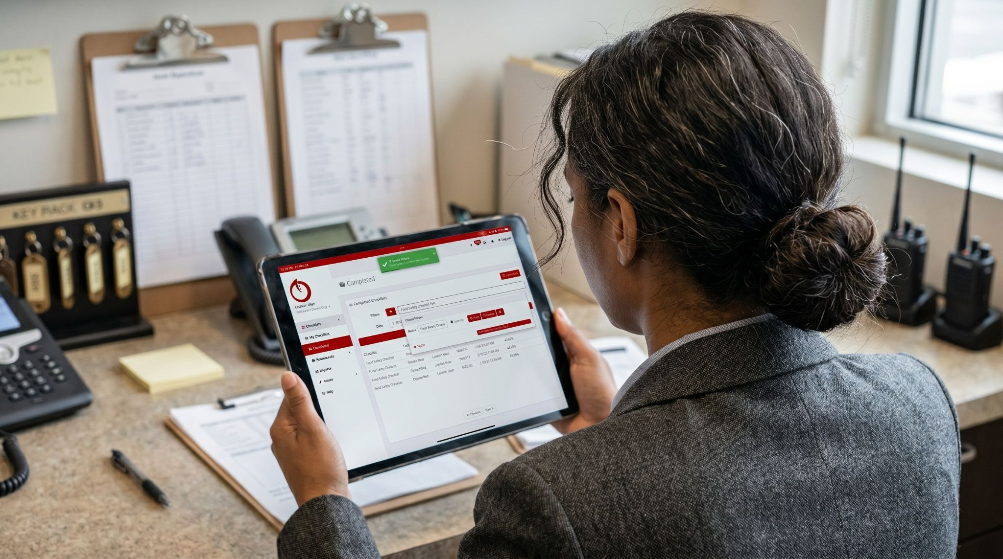 Manager reviewing tablet checklist