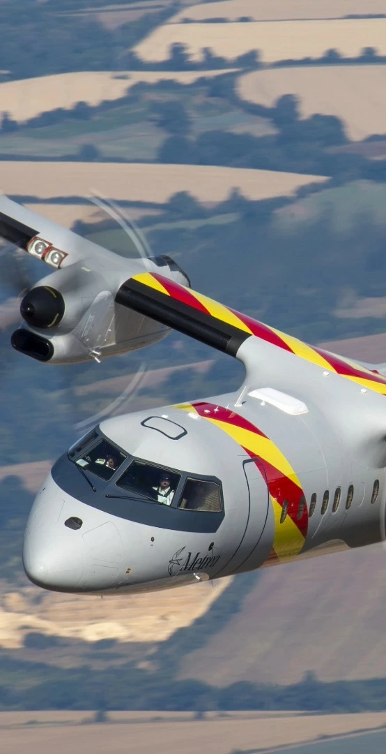 An firefighting aircraft with the Metrea logo flying while dropping a red powdered flame retardant below it