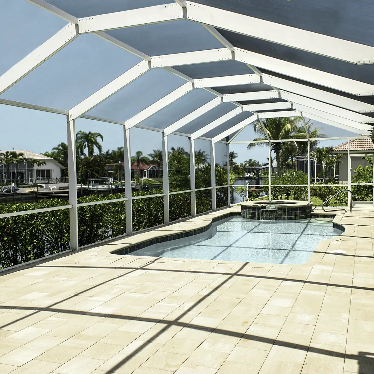 Premium custom aluminum pool screen enclosure installed over a luxury backyard swimming pool at a single-family home in Coral Springs, Florida.