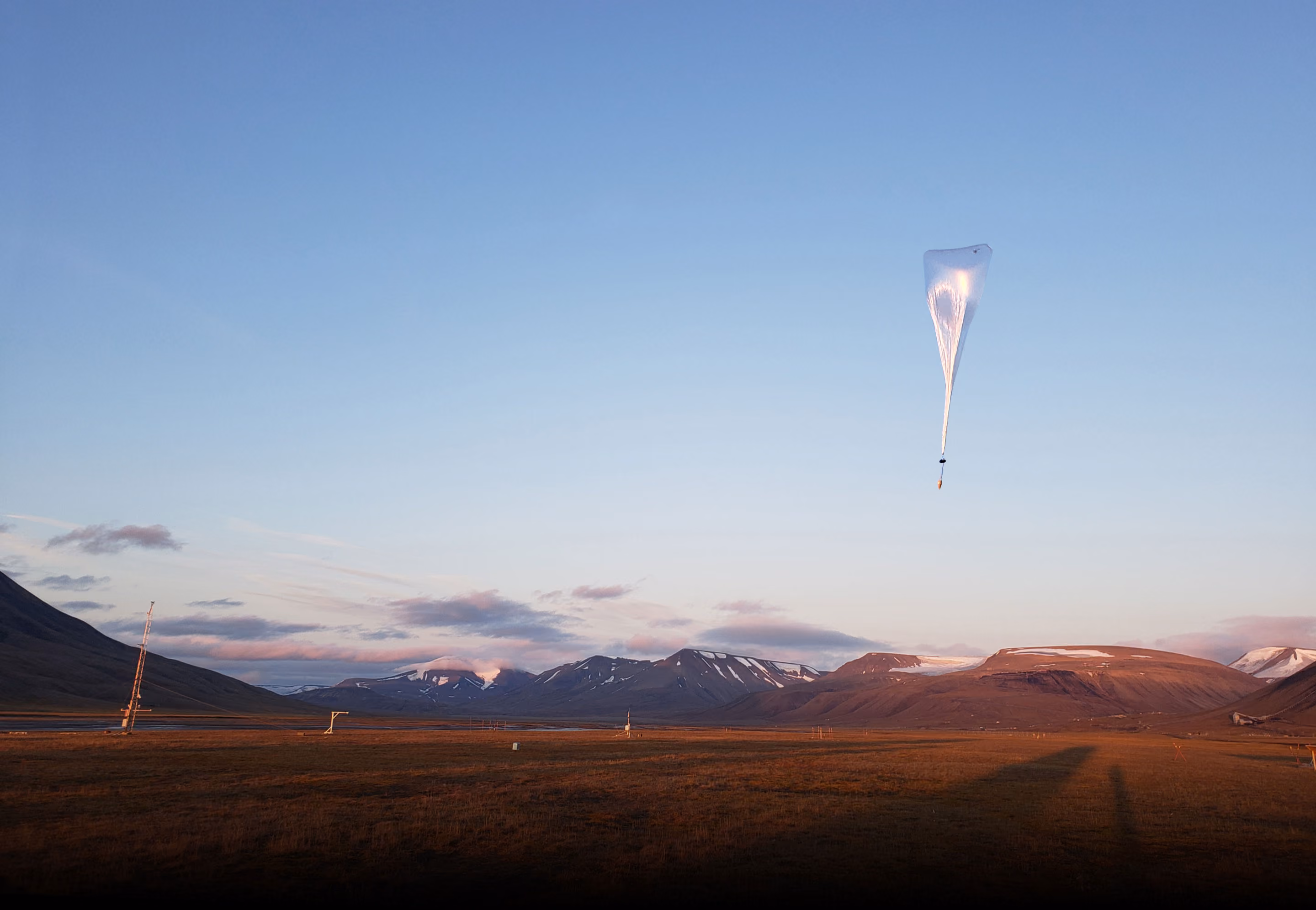 Balloon flying into sunrise