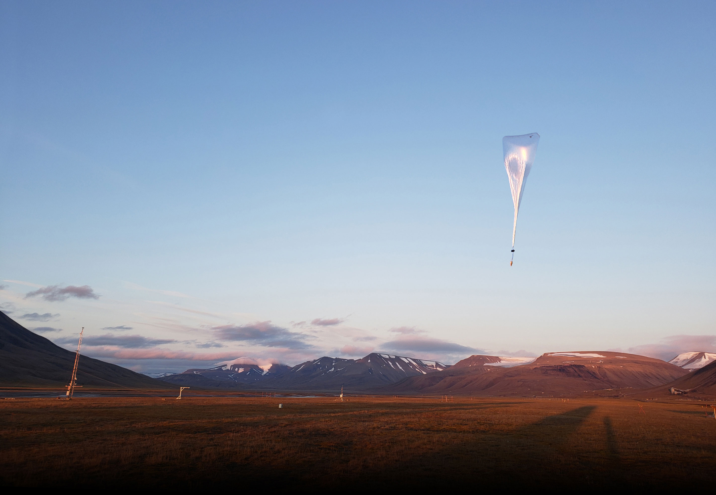 Balloon flying into sunrise