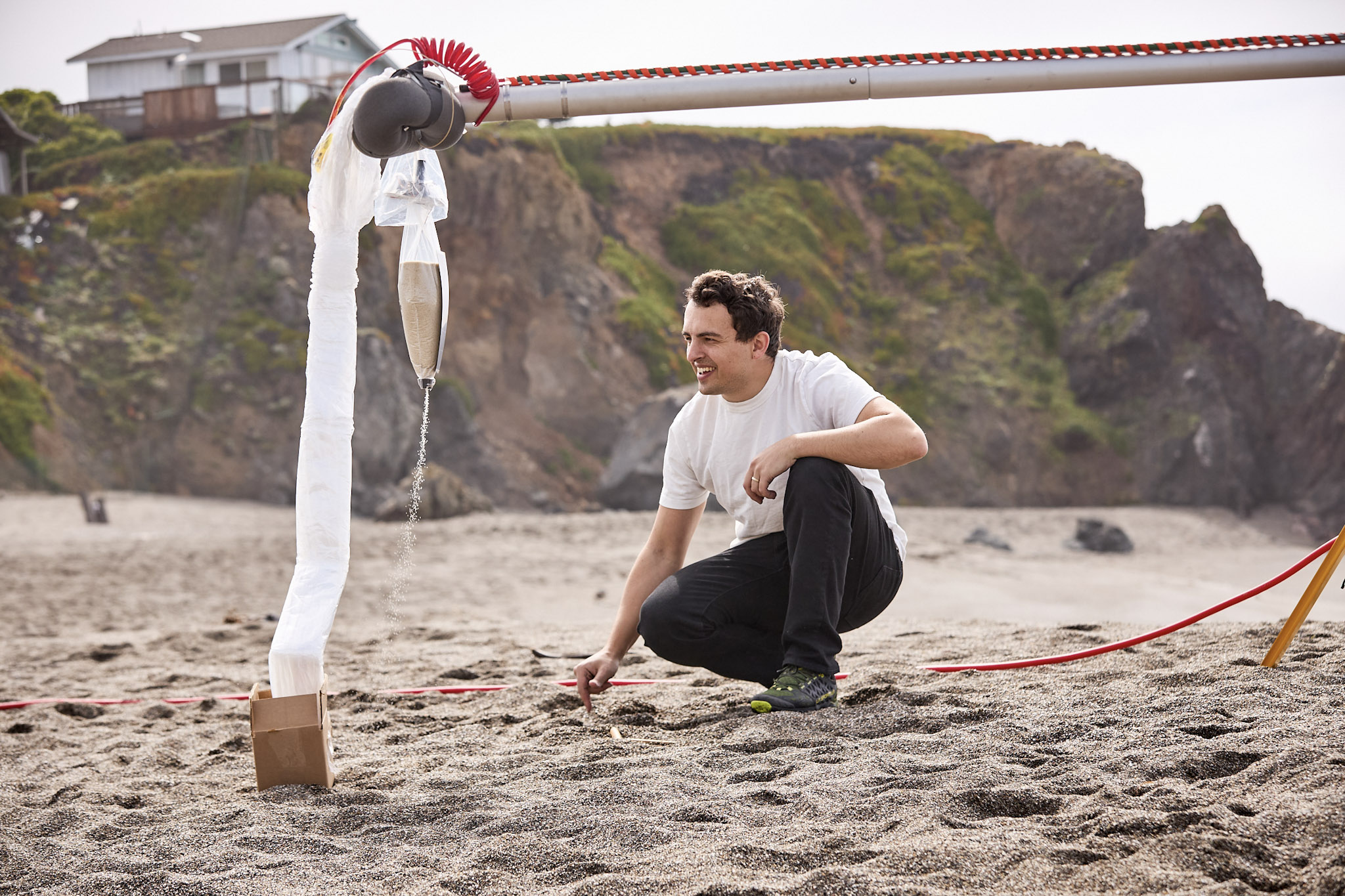 Engineer looking at WindBorne hardware on the beach