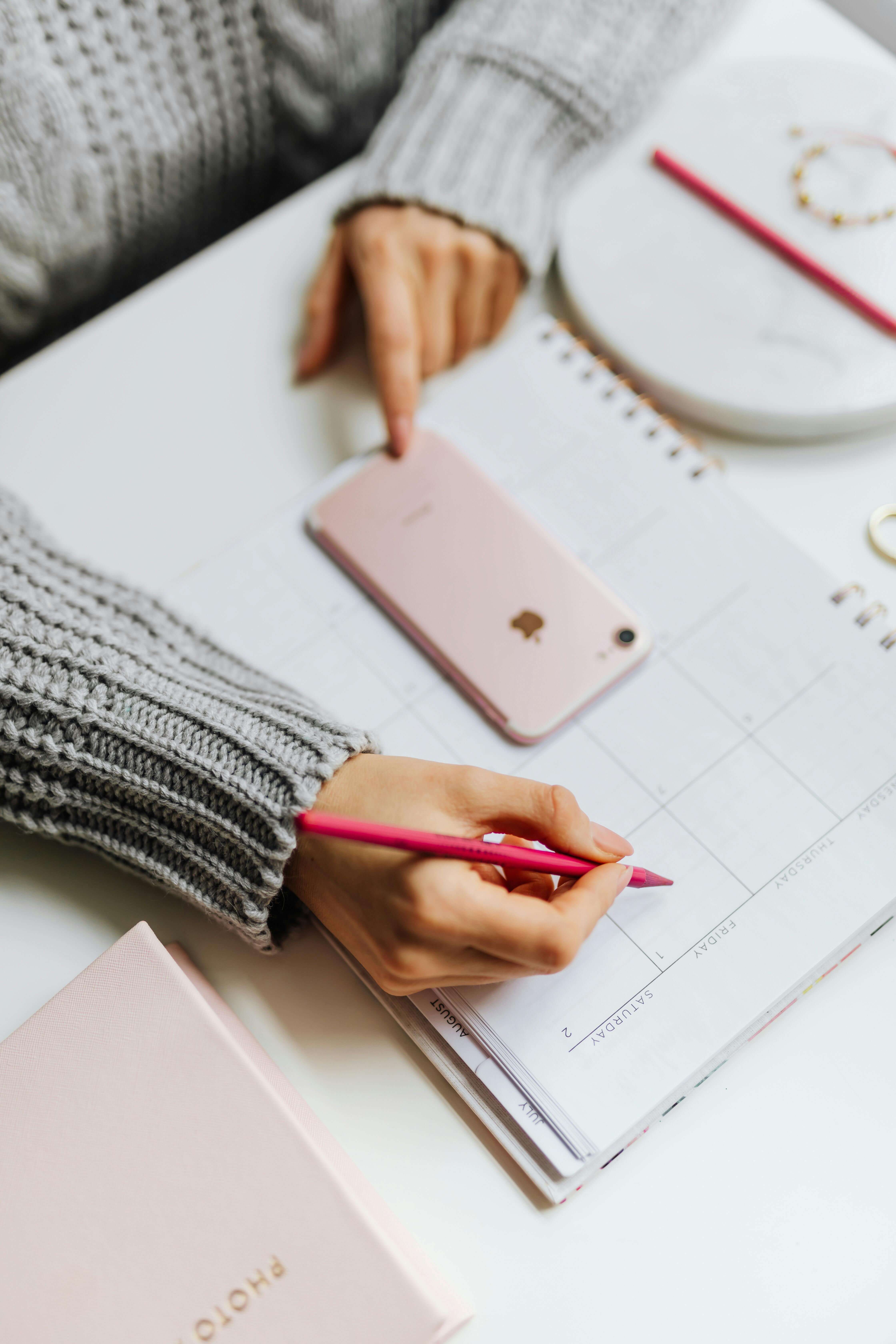 a person writing on a calendar