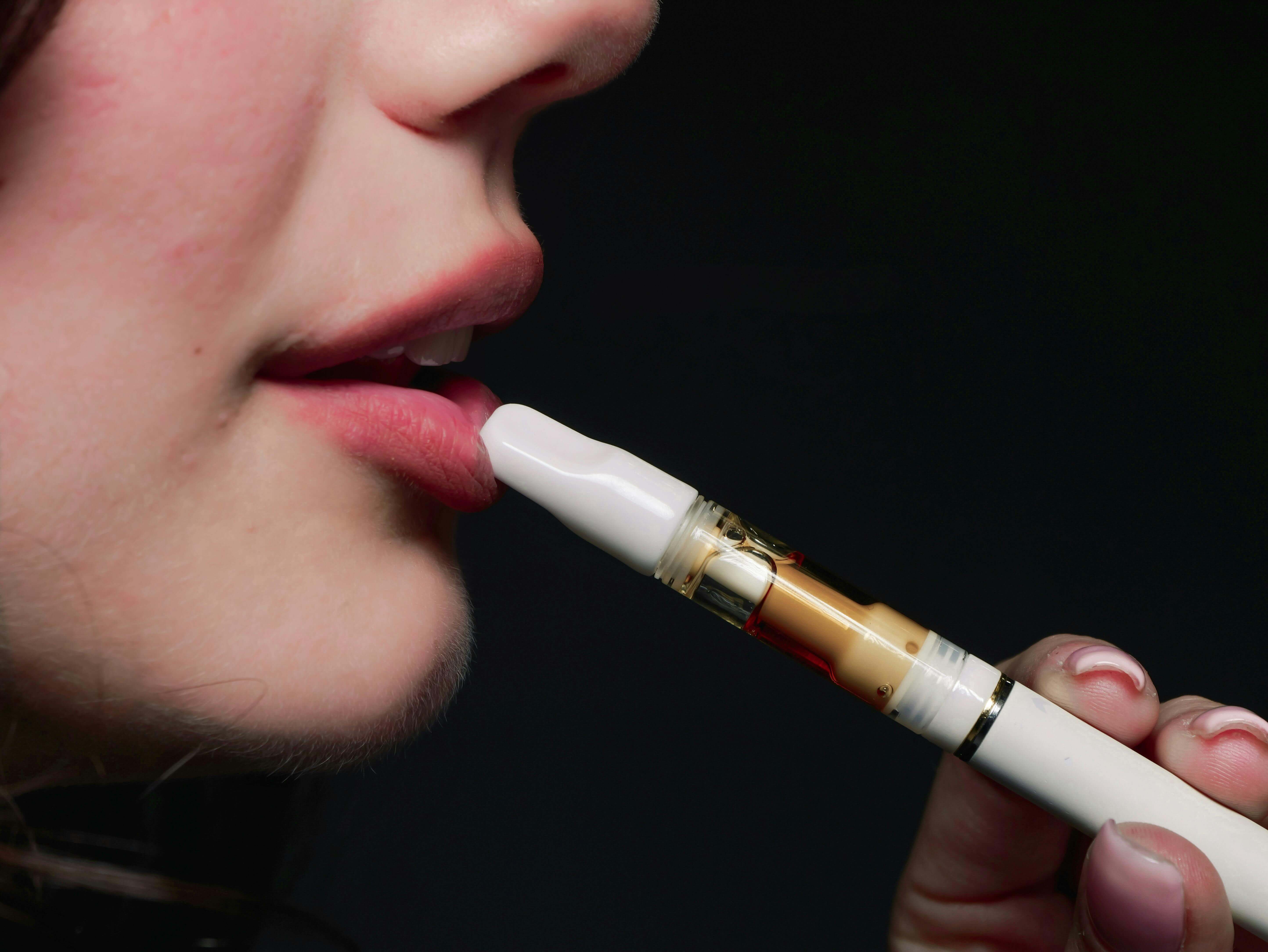 a person using a pen to use a cigarette