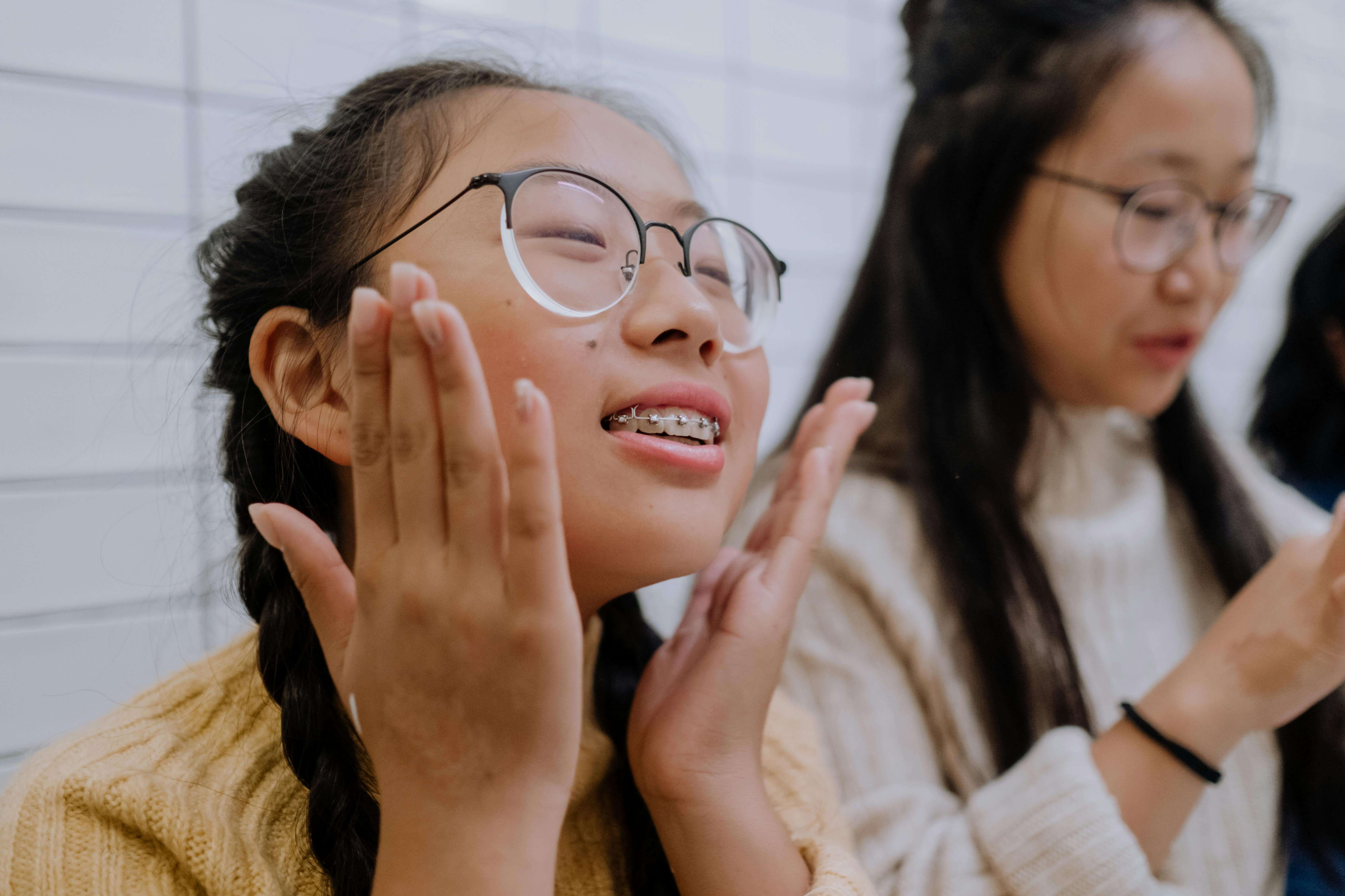 a girl with braces and glasses