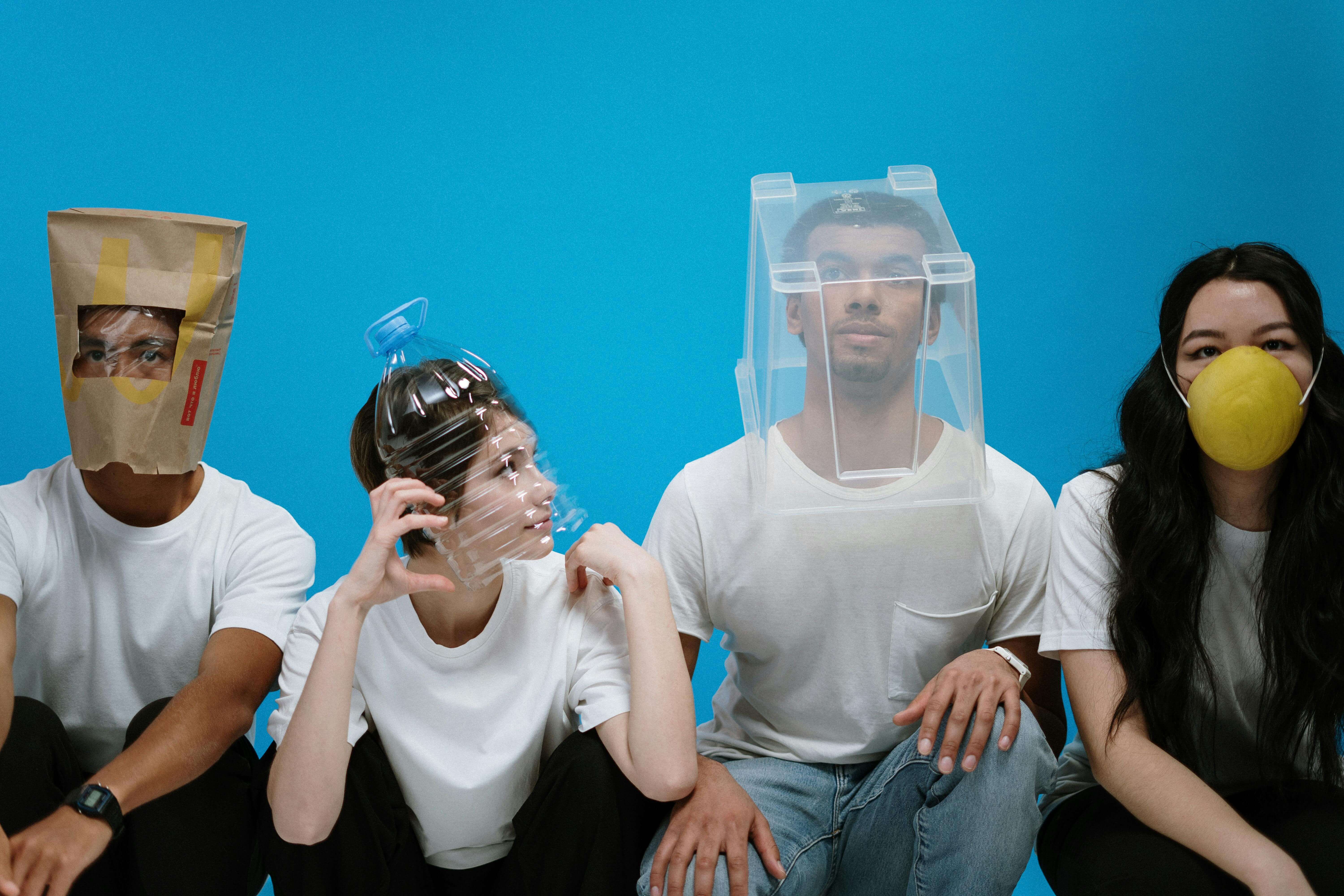 a group of people wearing plastic masks